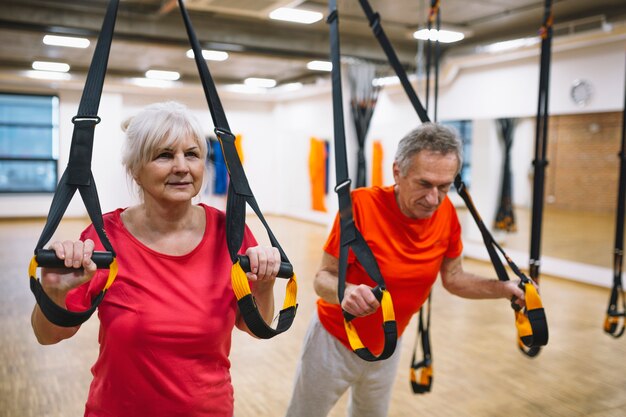 Retired couple working out in gym