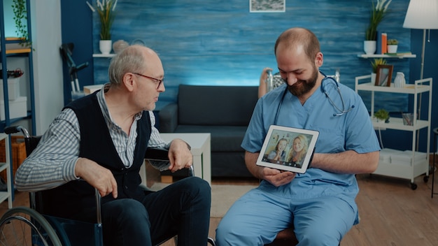 Retired man with disability talking to family on video call