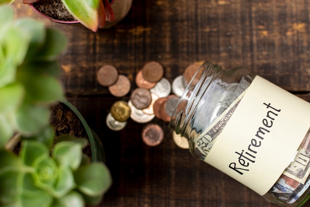 Retirement label on a jar filled with money top view Premium Photo