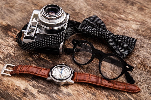 Free photo retro camera, watch, bowtie and glasses