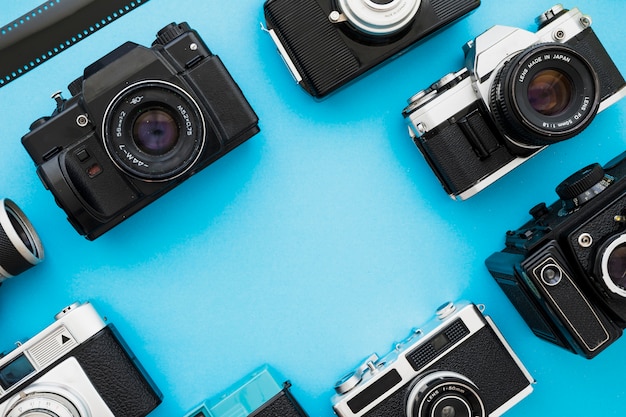 Retro cameras near piece of film