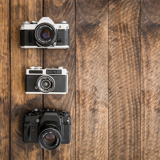 Free photo retro cameras on wooden tabletop