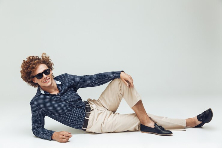 Free Photo retro man dressed in shirt lies on floor and posing