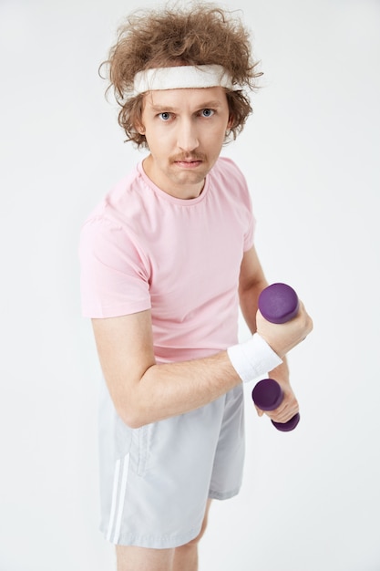 Retro man in pink t-shirt and grey sport shorts