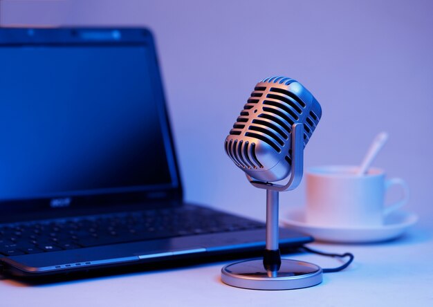 Retro microphone and notebook computer, live webcast on air concept