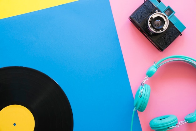 Retro music concept with vinyl, camera and headphones