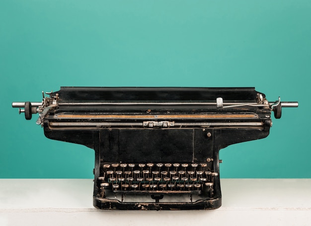 Retro old typewriter with paper on wooden table