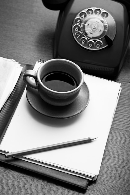 Retro phone, notebook and coffee cup