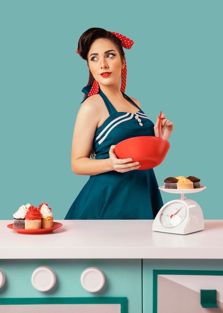 Free photo retro pinup girl posing in a kitchen