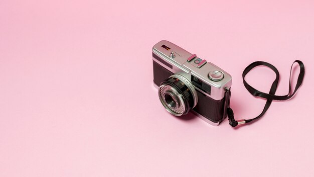 Retro styled camera on pink background