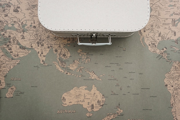 Free photo retro world map background with suitcase