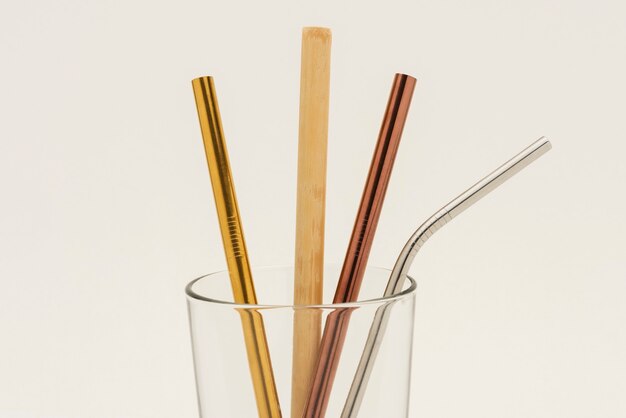 Reusable bamboo and metal straws in a glass