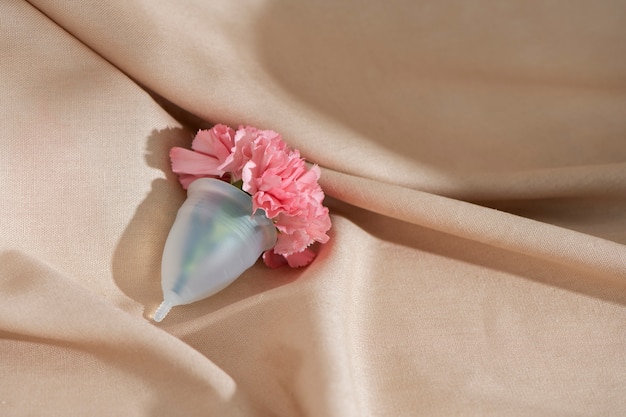 Free photo reusable menstrual cup product with flowers