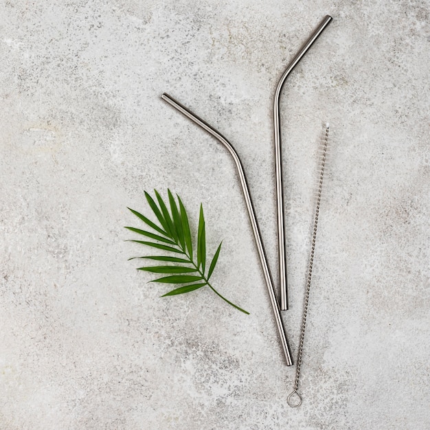 Free photo reusable metal silver straws top view