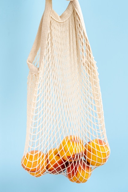 Reusable shopping mesh bag with fruits