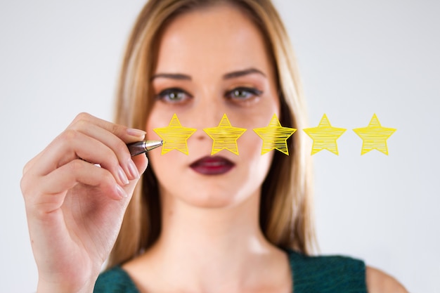 Free photo review, increase rating or ranking, evaluation and classification concept. businessman draw five yellow star to increase rating of his company