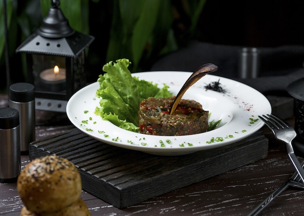 Rib eye steak in round shape with salad leaves