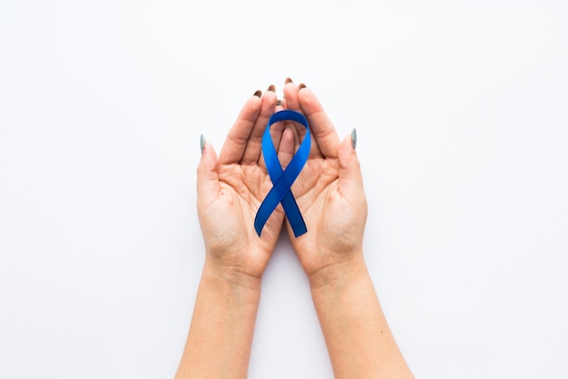 Ribbon of blue color on crop hands