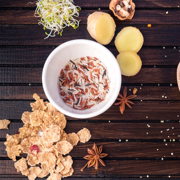 Rice in bowl with corn flakes on table