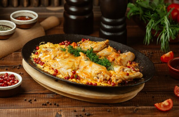 Rice garnish with herbs and chicken breast in iron plate