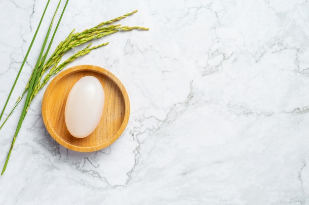 Rice milk soap put on wooden bowl with rice plants