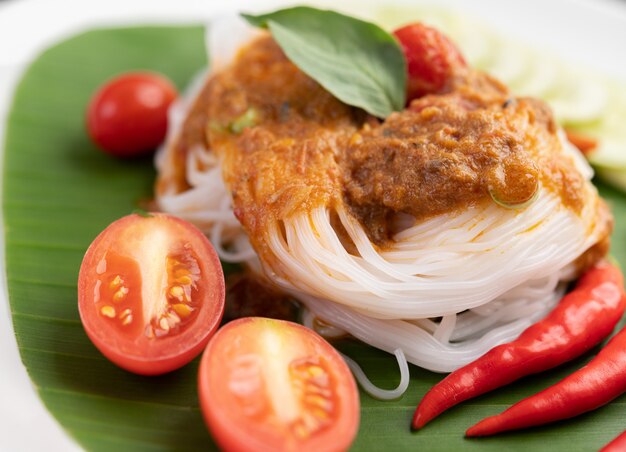 Rice noodle noodles topped with coconut milk.