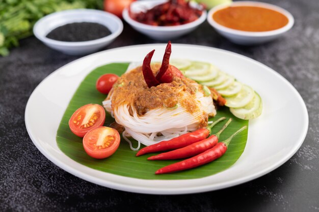 Rice noodle noodles topped with coconut milk.