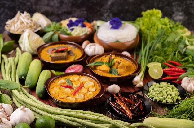 Rice noodles in a bowl of curry paste with chili, cucumber, long bean, lime, garlic and spring onion