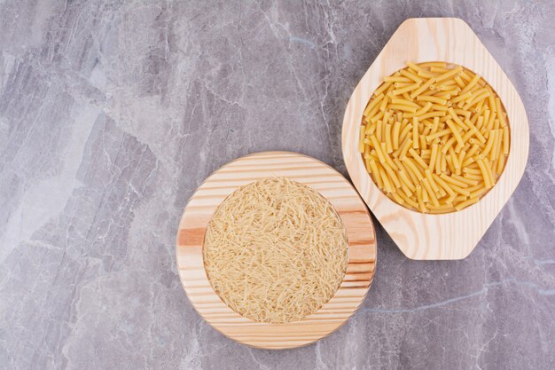 Rice and pasta made from it in separate plates