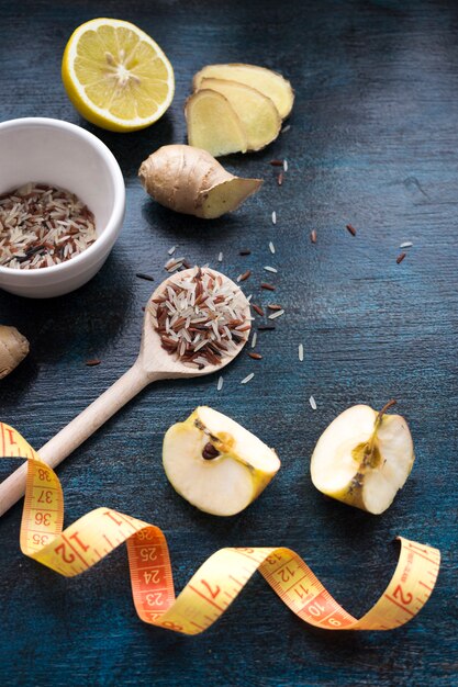 Rice in spoon with apples and measuring tape