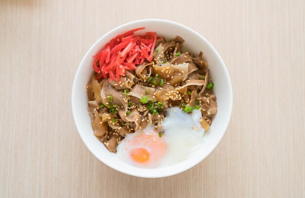 rice topped with slice pork and onsen egg