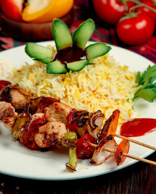 Rice with chicken and vegetables on a stick