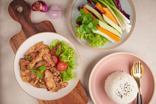 Rice with grilled pork neck. Grilled pork salad thai food with herbs and spices ingredients, tradition northeast food delicious with fresh vegetables, Hot and spicy slice grilled pork menu asian food.