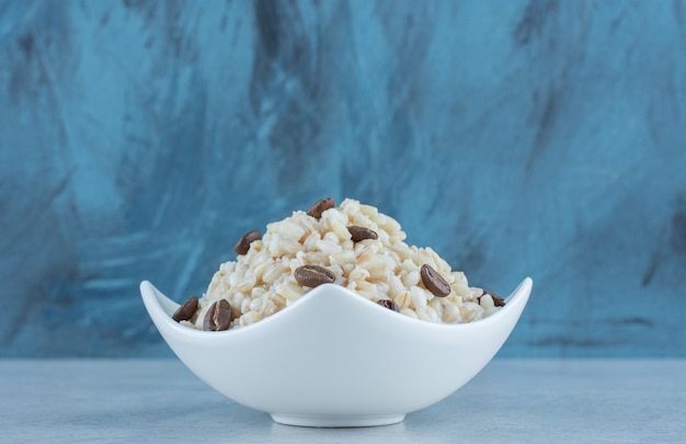 Rice with milk and coffee beans on marble.