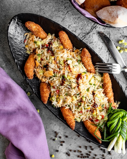 Rice with vegetables and chicken nuggets in batter