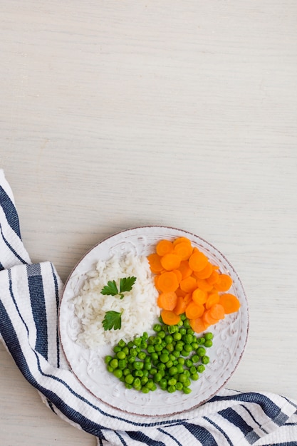 Rice with vegetables and green parsley on plate