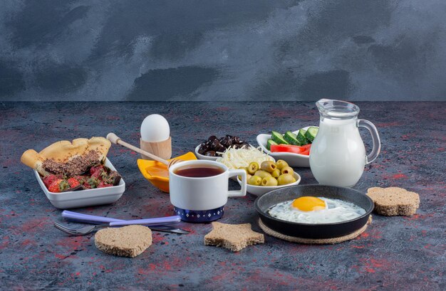 Rich breakfast table with variety of foods. 