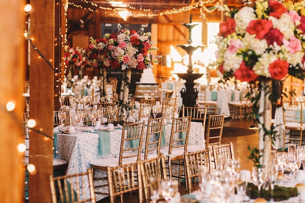 Rich dinner tables covered with blue clothes and sparkling glass