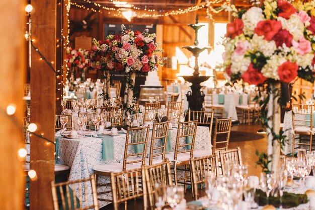 Rich dinner tables covered with blue clothes and sparkling glass