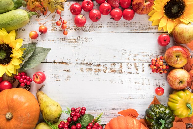 Rich harvest of vegetables and fruits on wooden surface