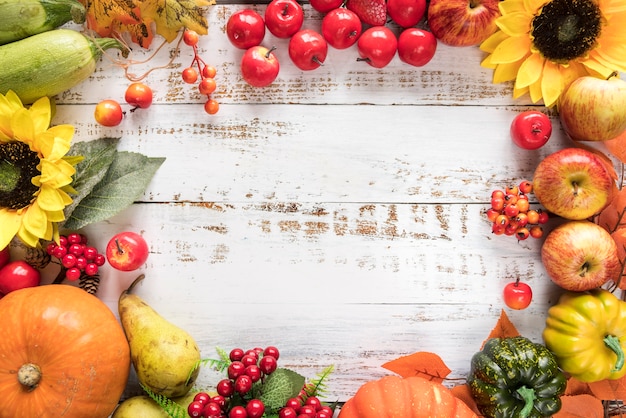 Rich harvest of vegetables and fruits on wooden surface