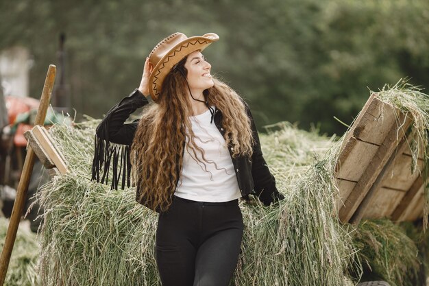 Rider woman does not look at the camera. Woman has long hair and black clothes