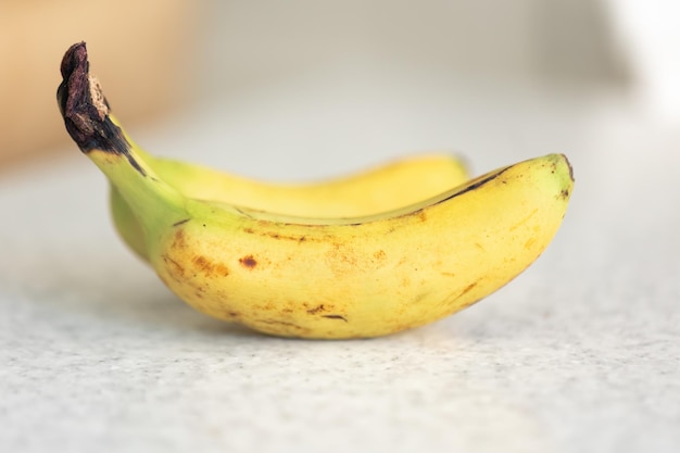 Free photo ripe bananas on a blurred light background