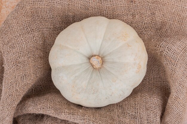 Ripe big pumpkin on burlap.