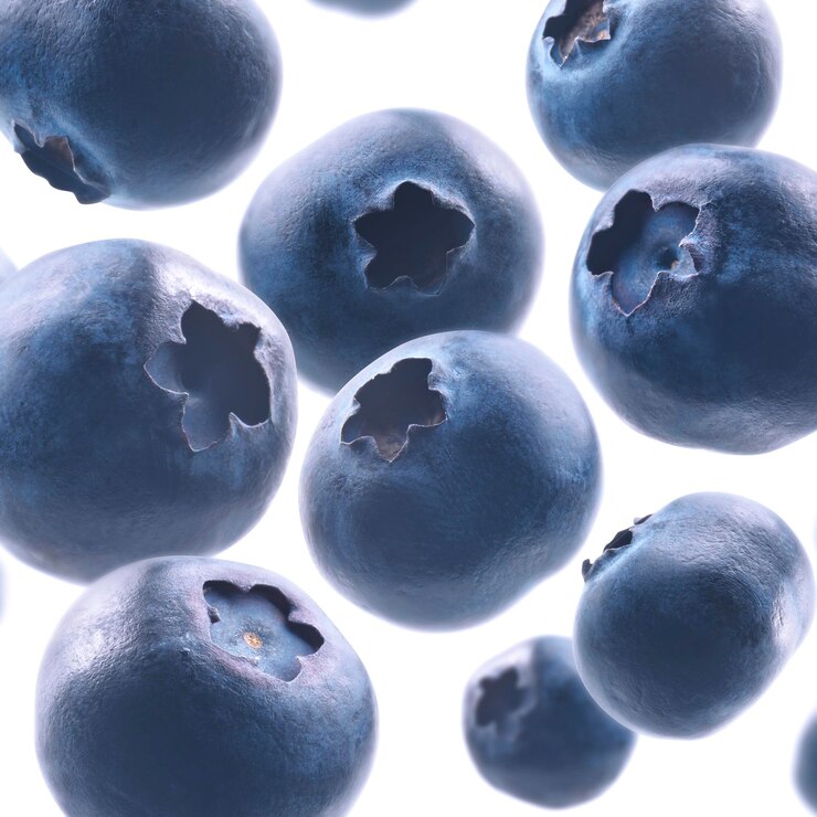 Ripe blueberries levitate on a white background