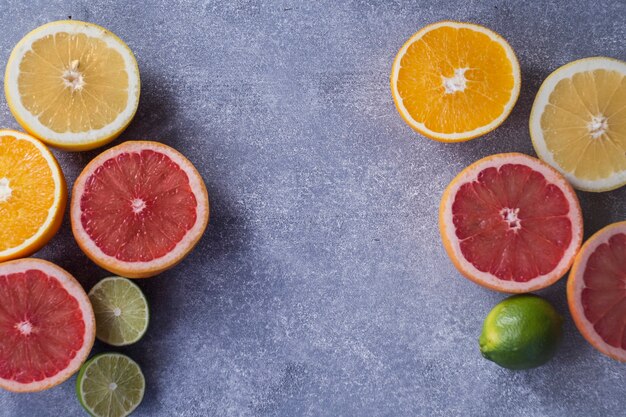 Ripe citruses on gray