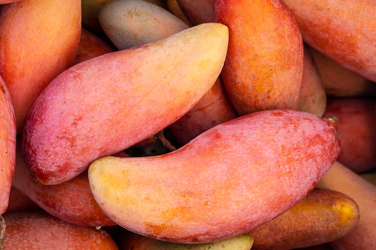 Free Photo ripe fresh red mango ready to sell - fruit background concept