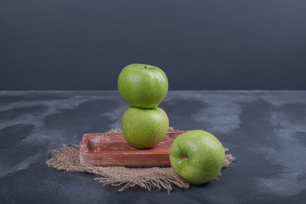 Ripe green apples on blue table.