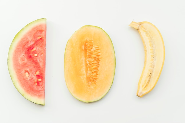 Ripe halved tropical fruits on background