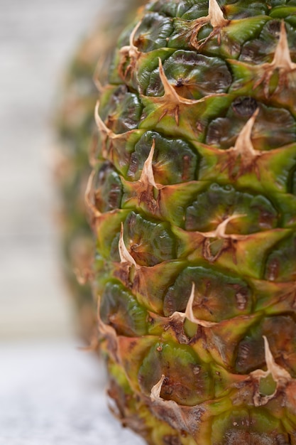 Free photo ripe juicy pineapples on grunge surface, close-up.